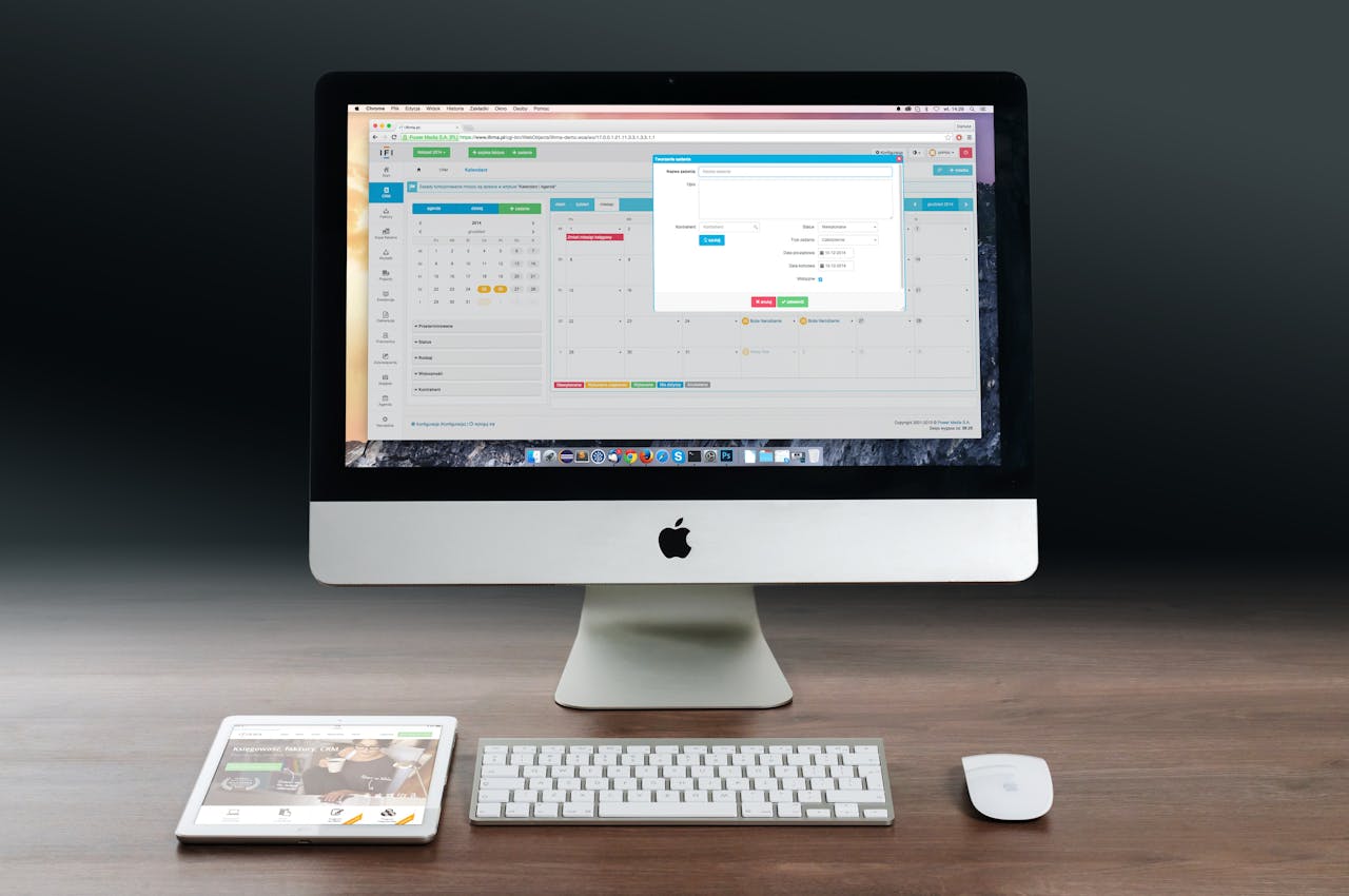 Crafting Captivating Headlines: Your awesome post title goes here A sleek office setup featuring an Apple iMac, iPad, and keyboard on a wooden desk.